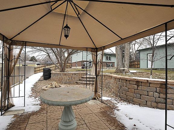 Beautiful backyard space includes a pagoda, great landscaping, and a firepit.