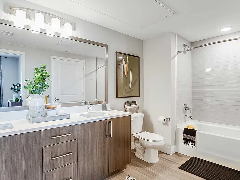 Bathrooms at The Wright feature contemporary cabinetry, quartz countertops, and clean modern finishes designed for comfort and everyday convenience.
