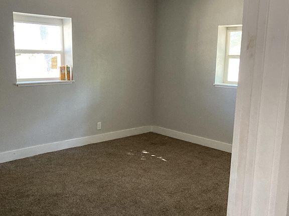 Bedroom 1 with its own closet, ceiling fan, and carpet.