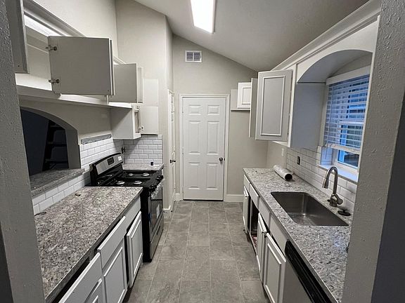 Kitchen with new stainless appliances (no fridge). New granite counters with larger single under mount sink. Subway backsplash and tons of storage.