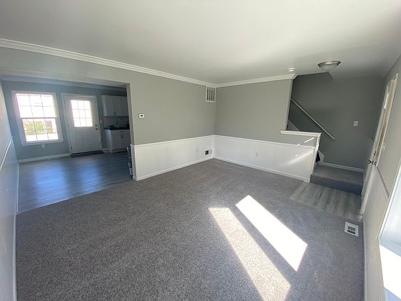 Living room view into dining/kitchen area