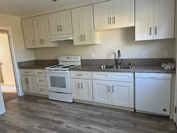 Looking into kitchen from living room. Hall on the left side of picture.