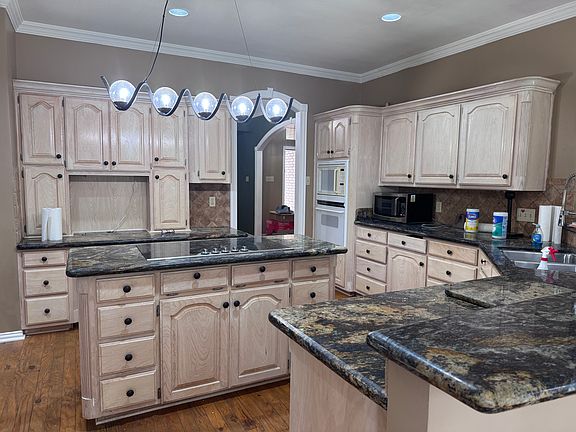 Custom ash cabinetry, exquisite countertops, double oven, microwave and extra microwave -