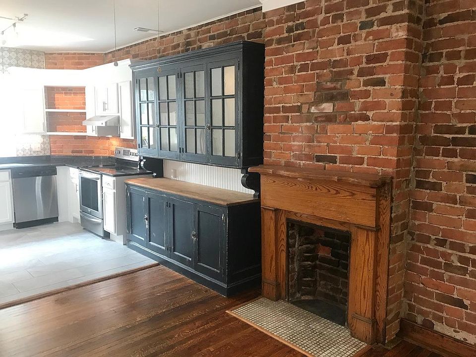 Here's the edge of the kitchen with a really cool original 1890's cabinet. Lots of exposed brick.