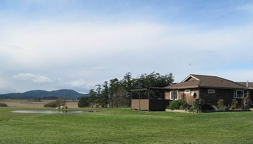 Valley vista, pond, house.