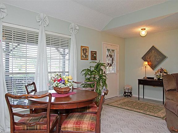 Front door opens into a tiled entry with a coat closet. Entry opens into the large living room. Wind