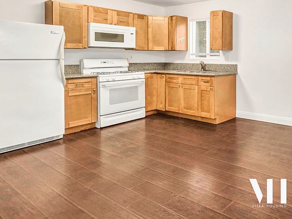 Full kitchen with matching all white appliances. Plenty of space for full dining and living room set