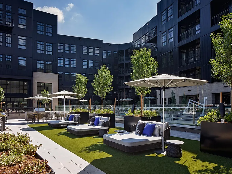 A welcoming outdoor courtyard with grilling spaces designed for shared meals and relaxed gatherings.