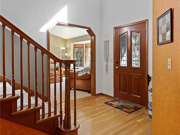 Spacious foyer with hardwood floors is inviting, light and airy.