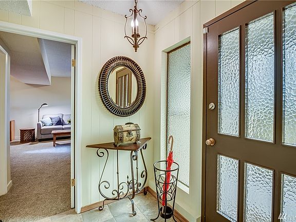 Beautiful tile entry inside front door leads to large master bed/bath and two-car garage.