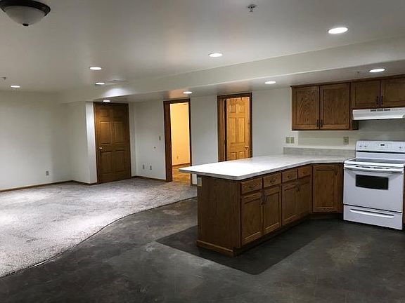 Kitchen opens into large living room with all new carpet.