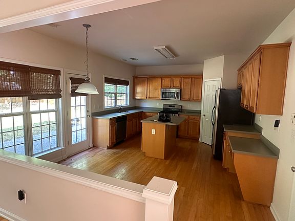 Kitchen with microwave, refrigerator, pantry and office built in counter top desk
