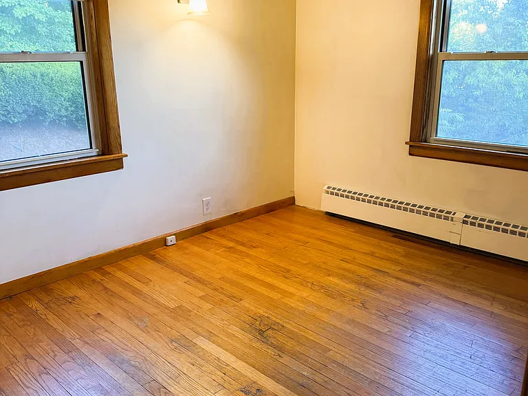 1st floor 4th bedroom with closet & hardwood floors