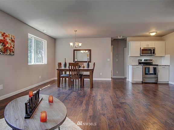 Living room open to kitchen and dining. 