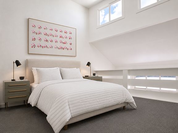 Loft bedroom with vaulted ceilings.
