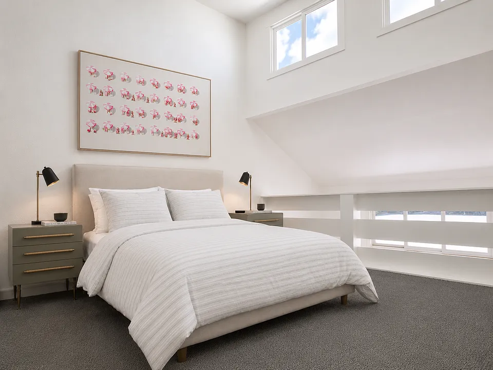 Loft bedroom with vaulted ceilings.