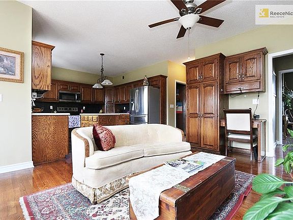 Hearth area of the kitchen. Built in desk is next to the pantry. Couch is facing the fireplace.