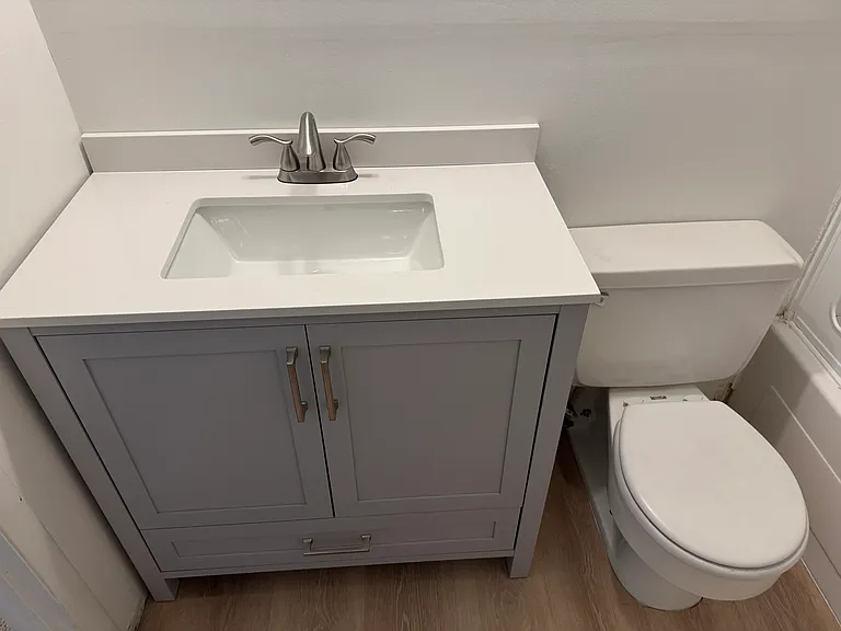 Upstairs Full Bath, with new Vanity, Light, Flooring.