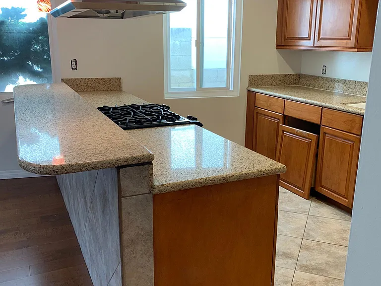 large kitchen with quartz counter-tops & breakfast counter