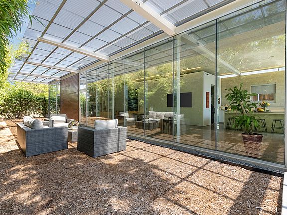 Luxurious outdoor furniture in a private setting ... underneath the filtered light of this museum-like awning.