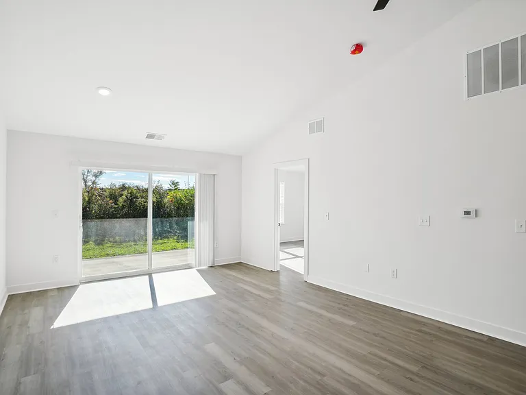 *' sliding glass door with vertical blinds leads to covered porch with private rear view