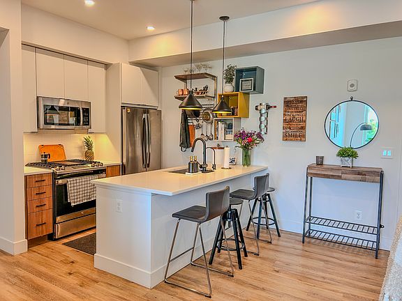 Island style kitchen with white granite countertops.
