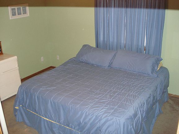 Master bedroom easily fits dressers and king size bed.