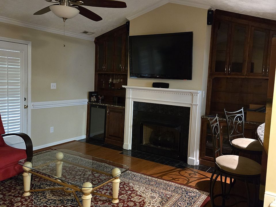 Living Room, Tv, Fire Place, Ceiling Fan and Light with access to Balcony overlooking a golf course