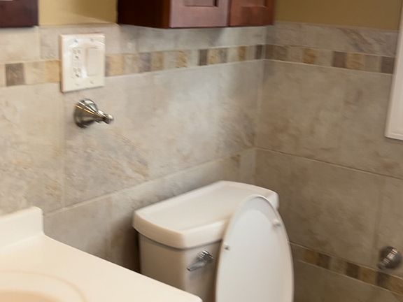 Bathroom New Tiled Bathtub and Rainforest Shower Head