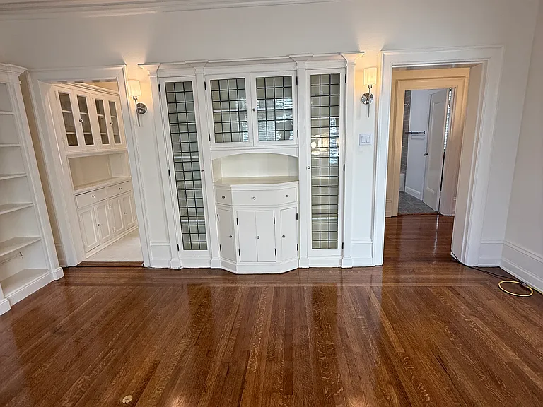 built in cabinet with leaded glass doors. Kitchen entry is on the left, hallway & bath entrance on the right