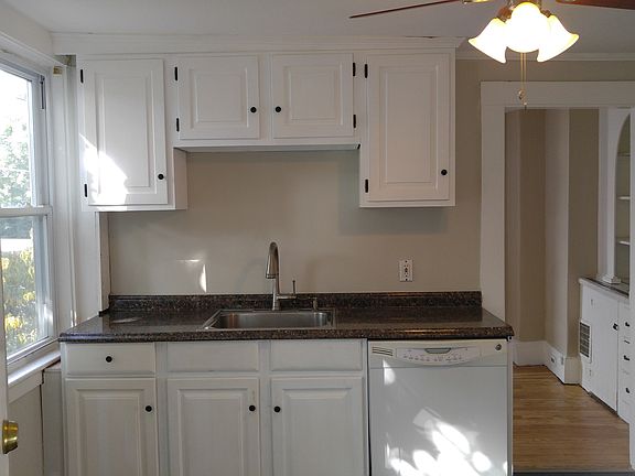 Kitchen: Dishwasher, refrigerator. Leads into dining room with built-in shelves and drawers.