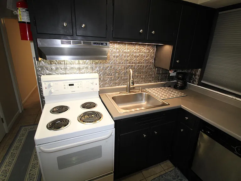 Kitchen with Over Range Fan and easy clean backsplash