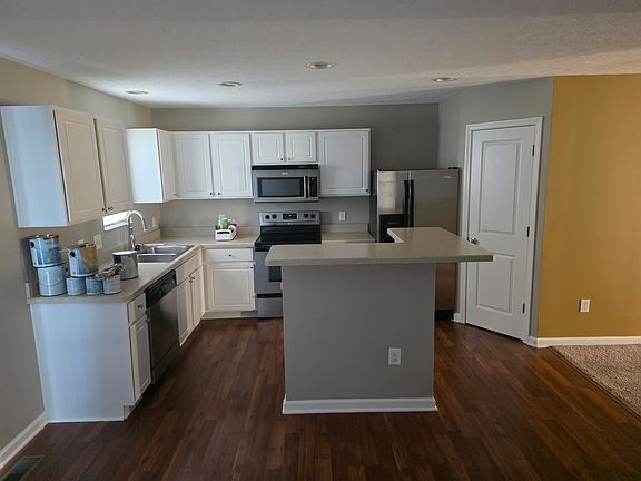 Kitchen space with laminate/wood flooring and walk in pantry space.