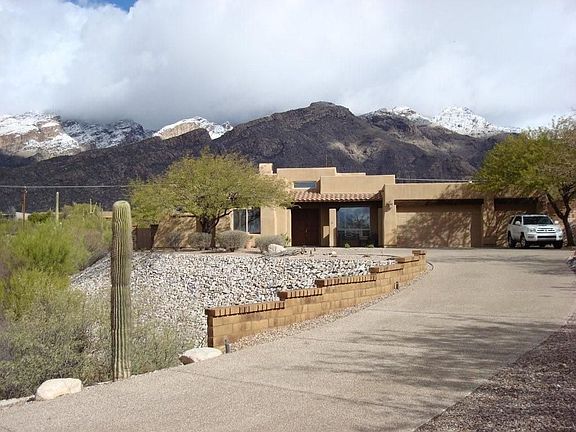 Long composite driveway leads to home, which is set high on a view lot