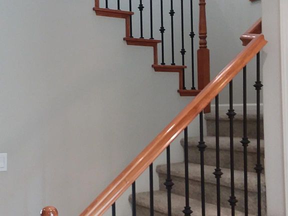 Stairwell seen from gracious entryway with plenty of room for an armoire or entry table, etc. Also has a large coat closet that extends below the stairway for extra storage.