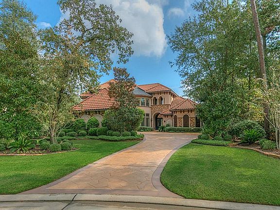 Private lot surrounded by mature shade trees.