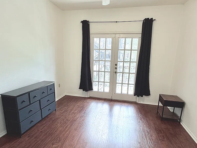 The first bedroom walk to the balcony via a nice big French door which brings good natural lights for study. A dresser and a night stand as a compliment.