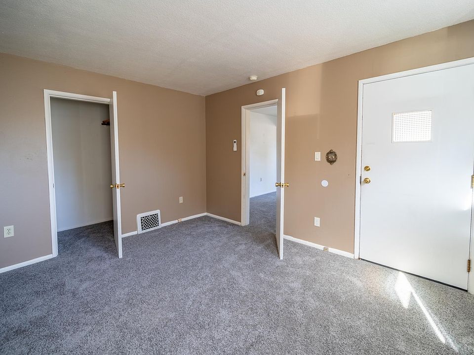 Living room with large walk in closet.