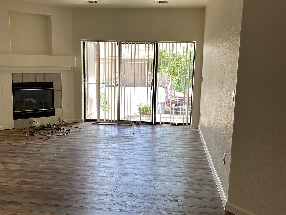 Large living area with new plank flooring, gas fireplace