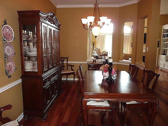 Architectural Cut Outs Open the Dining Room to the Den and Entryway.