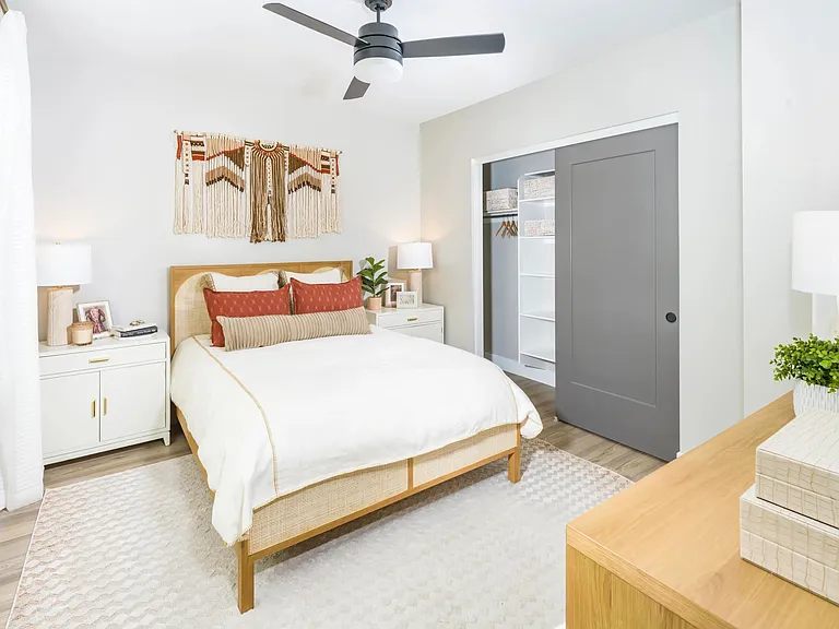 Cozy and bright bedrooms feature sleek ceiling fans, warm neutral tones, and built-in storage to keep your space feeling calm and collected.