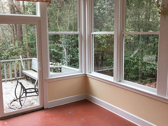Beautiful sun room with windows on 3 sides and sliding door