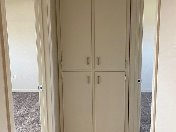 Linen closet at end of hallway