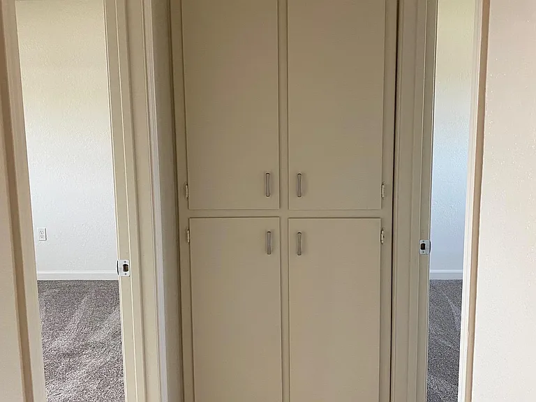 Linen closet at end of hallway