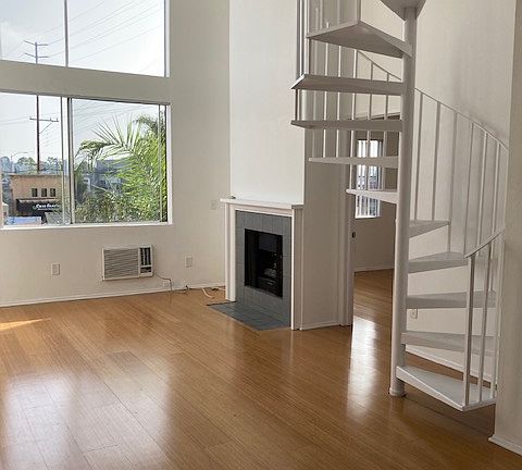 Double-height living room with working gas fireplace