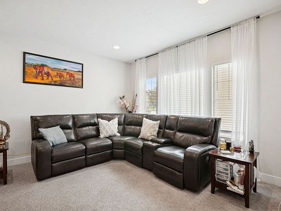 The living room is spacious and can fit a large sectional.