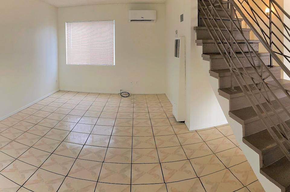 Panoramic view from the front door. Downstairs bedroom to the left, living room in the center, kitchen and half-bath to the right of the staircase.