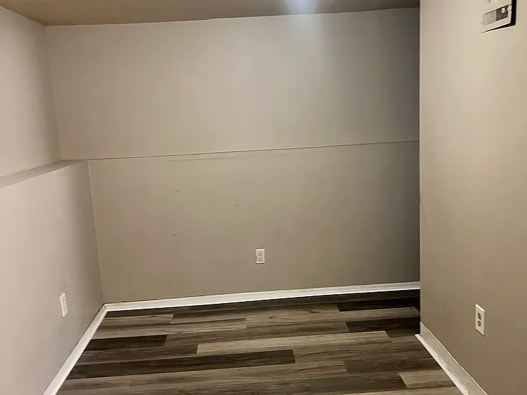 Downstairs bedroom walk in closet and wimdow behind the wall