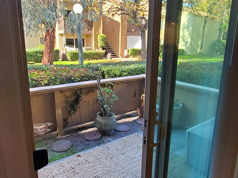 Private patio overlooks grassy area and fountains