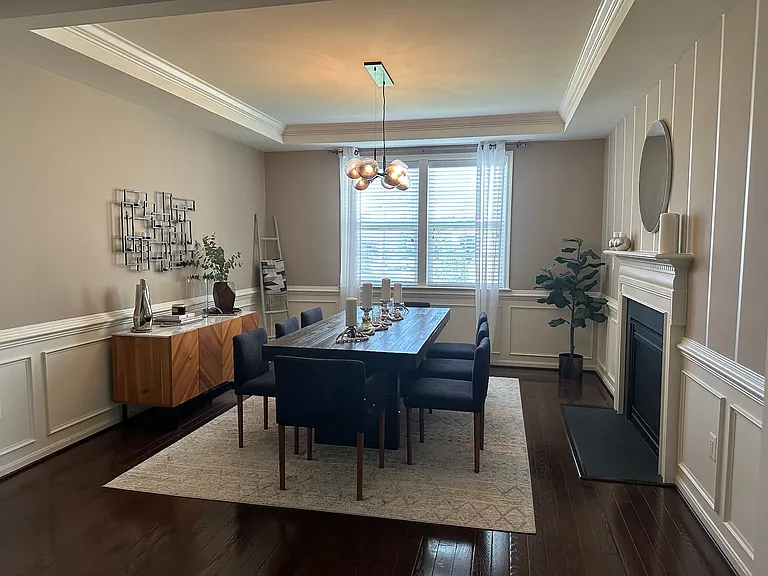Dining Room with coffered ceiling, chair rail, and fireplace